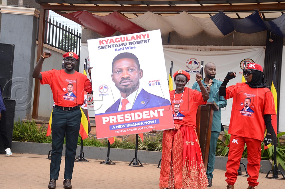 NUP party supporters holding the campaign portrait of Robert Ssentamu Kyagulanyi that was unveiled on Wednesday at Makerere Kavule in Kampala. (Photo by Isaac Nuwagaba)