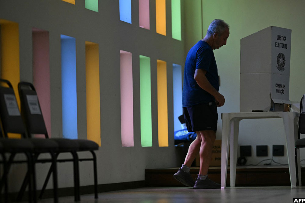 A man votes during the presidential runoff election at a polling station in Rio de Janeiro
