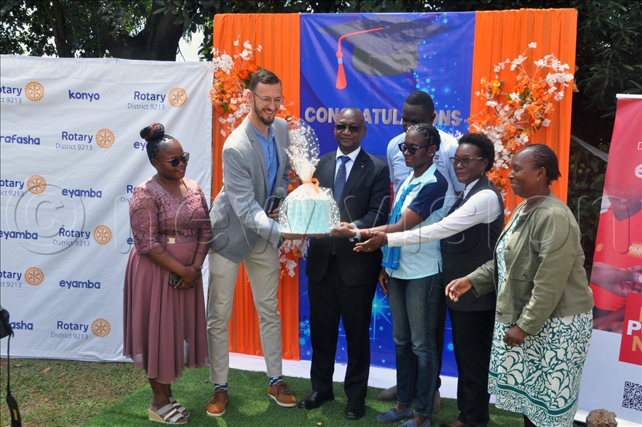 Rotary District 9213, Rotary club, BISS Bakeries Uganda officials hold a cake during the graduation ceremony held at BISS Bakeries Uganda in Katalemwa, Wakiso District. (Credit: John Odyek)
