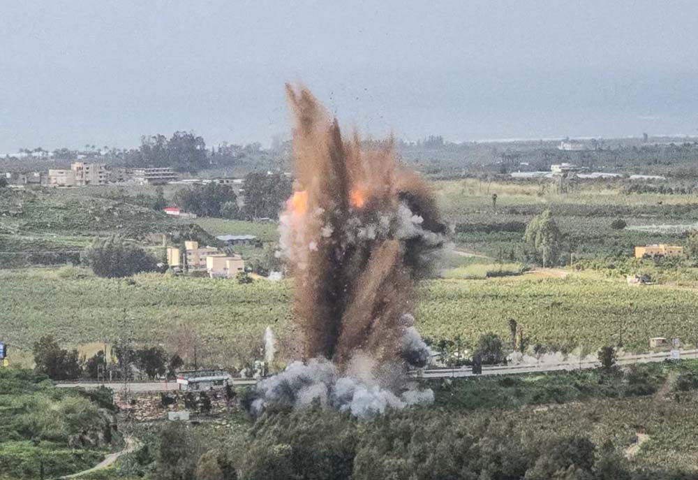 A fireball rises from the site of an Israeli airstrike that targeted the Qasmiyeh bridge, located on a main highway linking villages in the Tyre district with others further north, after Israel said the bridge was being used by Hezbollah, in southern Lebanon on March 22, 2026. (Credit: AFP)