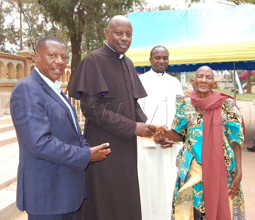 L-R: Eng. Pius Mugalasi, Msgr. Rogers Kabuye and Fr. John Mary Walugembe share a photo-moment wth Jajja Dativa Nabukalu who travelled all the way from Masaka to see the on-going renovations on Lubaga Cathedral. (Photo by Mathias Mazinga)