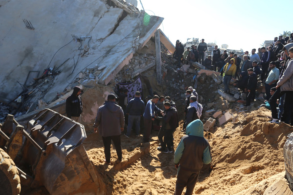 Palestinians search through the rubble of a building at the site of an Israeli strike in Khan Yunis in the southern Gaza Strip on March 23, 2025. (Photo by AFP)