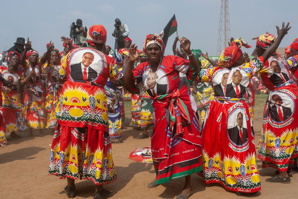 Malawi Congress Party (MCP) supporters dance ahead of the arrival of incumbent Malawi president and MCP presidential candidate Lazarus Chakwera during MCP's final campaign rally at Civo Stadium in Lilongwe, on September 13, 2025. (Photo by Amos GUMULIRA / AFP)
