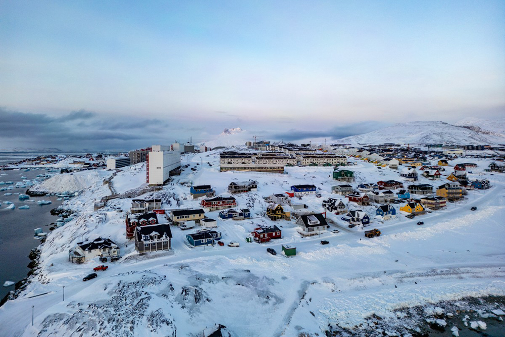 This aerial view shows snow-covered buildings in Nuuk, Greenland, on March 7, 2025. Greenland, the autonomous Danish territory, will hold legislative elections on March 11. (Photo by Odd ANDERSEN / AFP)