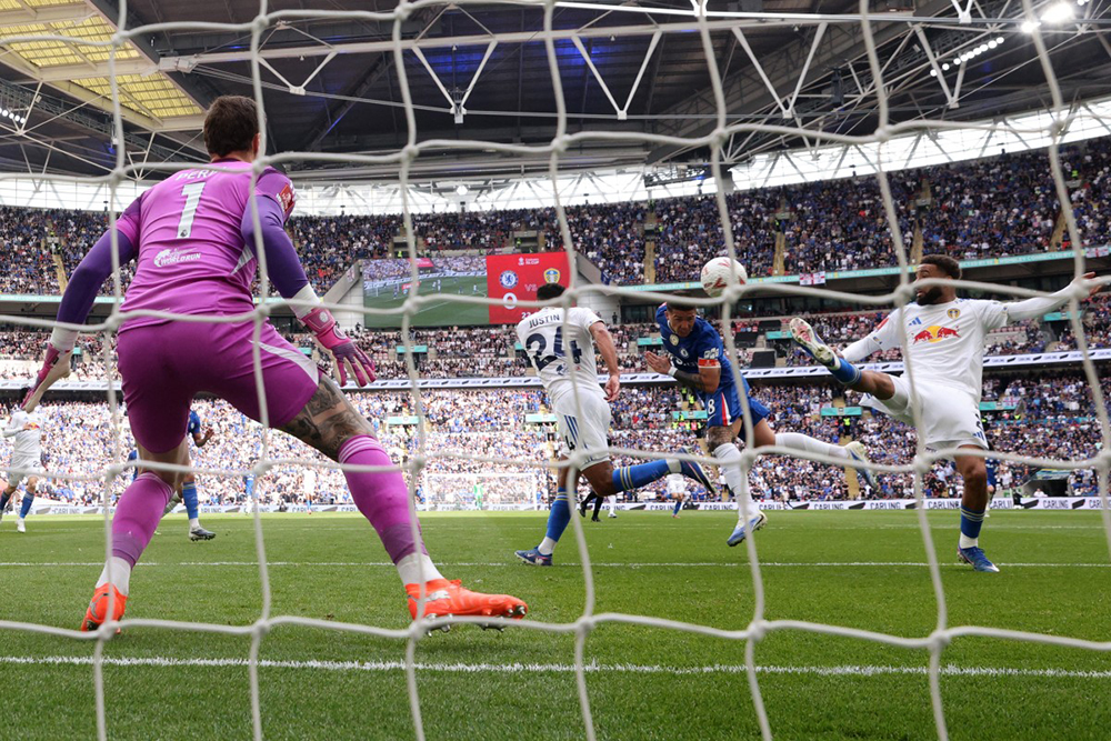 Chelsea's Argentinian midfielder #08 Enzo Fernandez (2R) heads in the opening goal during the English FA Cup semi final football match between Chelsea and Leeds United at Wembley stadium in London, on April 26, 2026. 