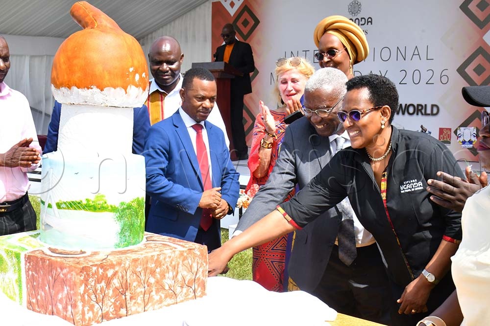 The Minister of Tourism, Wildlife and Antiquities, Col. (Rtd) Tom Butime (2nd R) joined by Doreen Katusiime (R), the permanent secretary of the Ministry of Tourism and Mirjam Blaak (3rd R) the Netherlands-born Ugandan Ambassador to Belgium, in cutting a cake while at celebrations to mark the International Museums Day at the Jinja Rugby grounds on May 18th. Looking on is UHTTC's Principal Richard Kawere (3rd L). (Credit: Donald Kiirya)