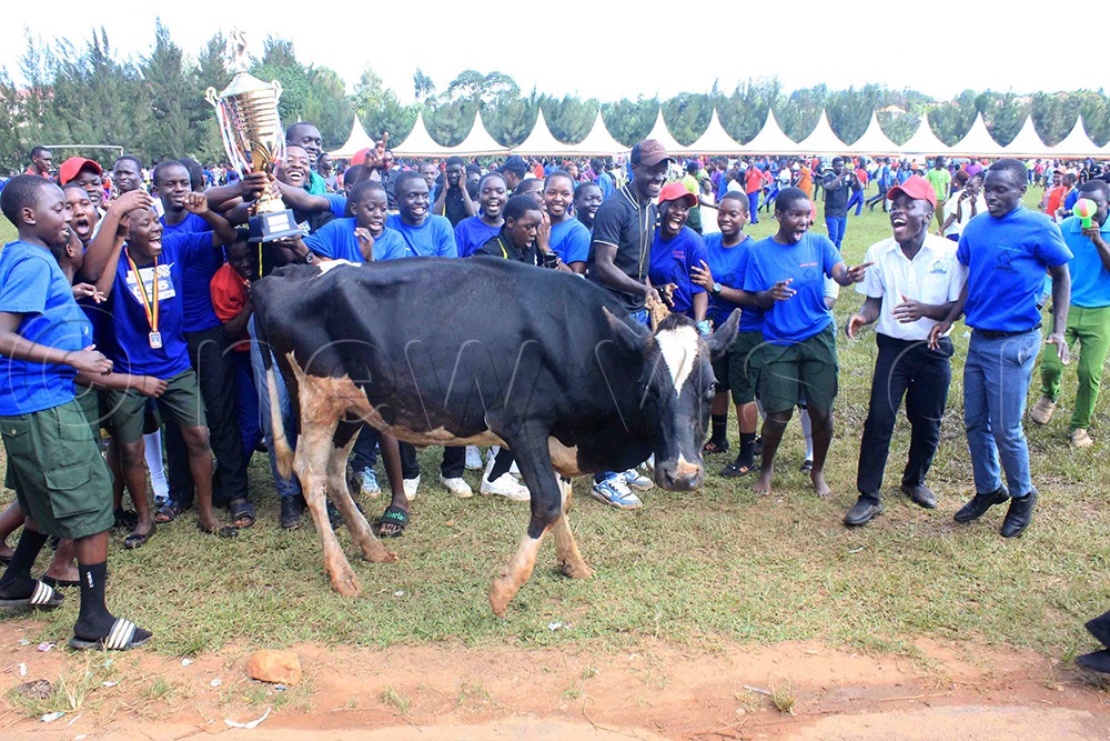  Lumumba House members celebrate their victory with a bull and a trophy. (Photo by Henry Nsubuga)