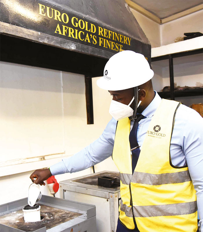 A worker operating a mineral smelting machine at the Euro Gold Refinery