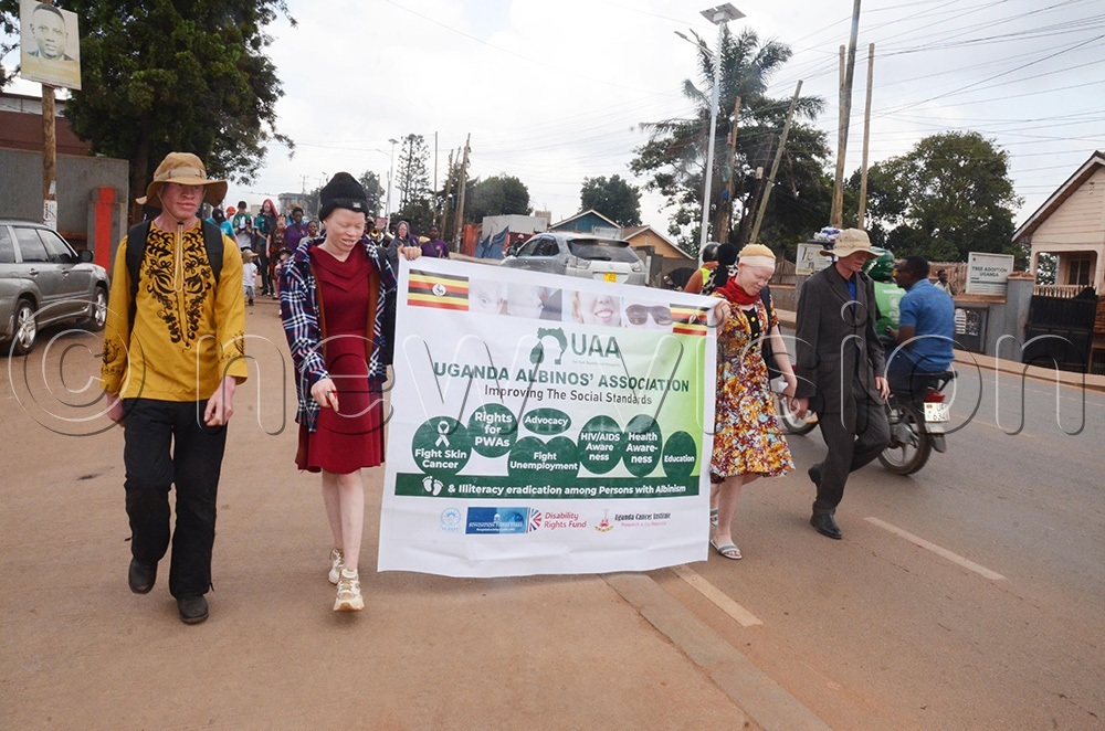 Members of Uganda Albinos Association (UAA) matching to hand over their petition to the to the executive director of the Uganda Cancer Institute (UCI), Dr Jackson Orem on Wednesday June 10, 2026. (Photo by Isaac Nuwagaba)