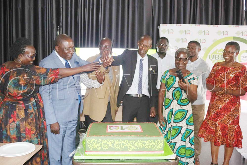 Connie Acayo assistant commissioner Ag-Extension (MAAIF) (left), with other Uganda Biotechnology and Biosafety Consortium participants cutting the cake