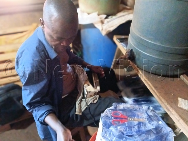 The man packing drinking water at his stall in Walukuba in Jinja city. (Credit: Doreen Musingo)