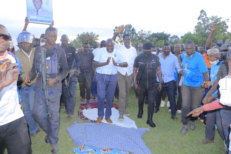 FDC supporters lay clothes for Nandala Mafabi to walk on some what of a Jesus style.