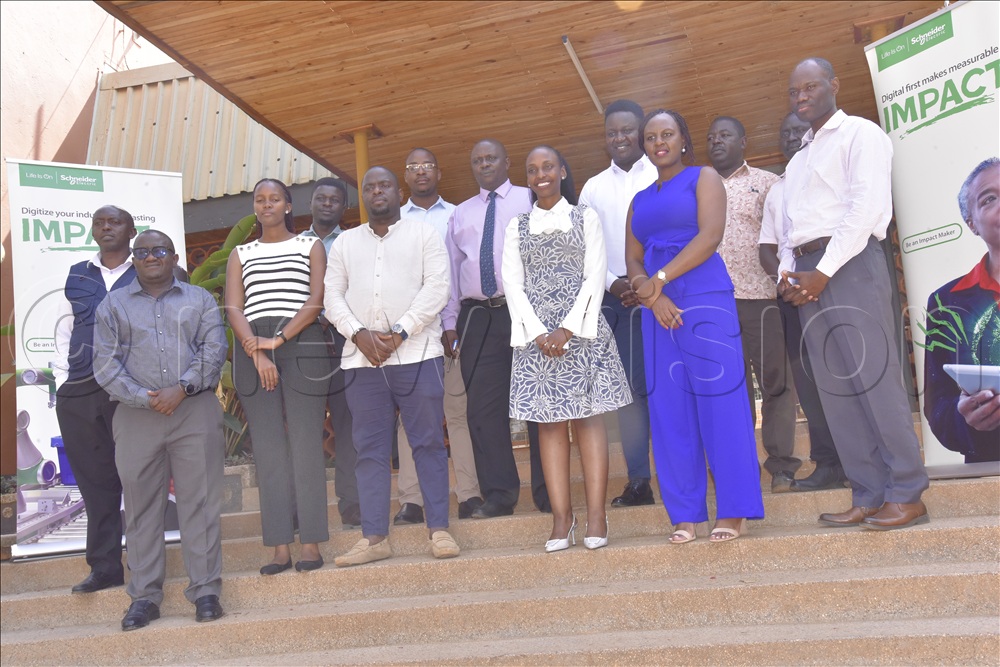 EACOP, Schneider and NVTC staff standing at the main entrance of the administration block of NVTC after signing the MOU.
