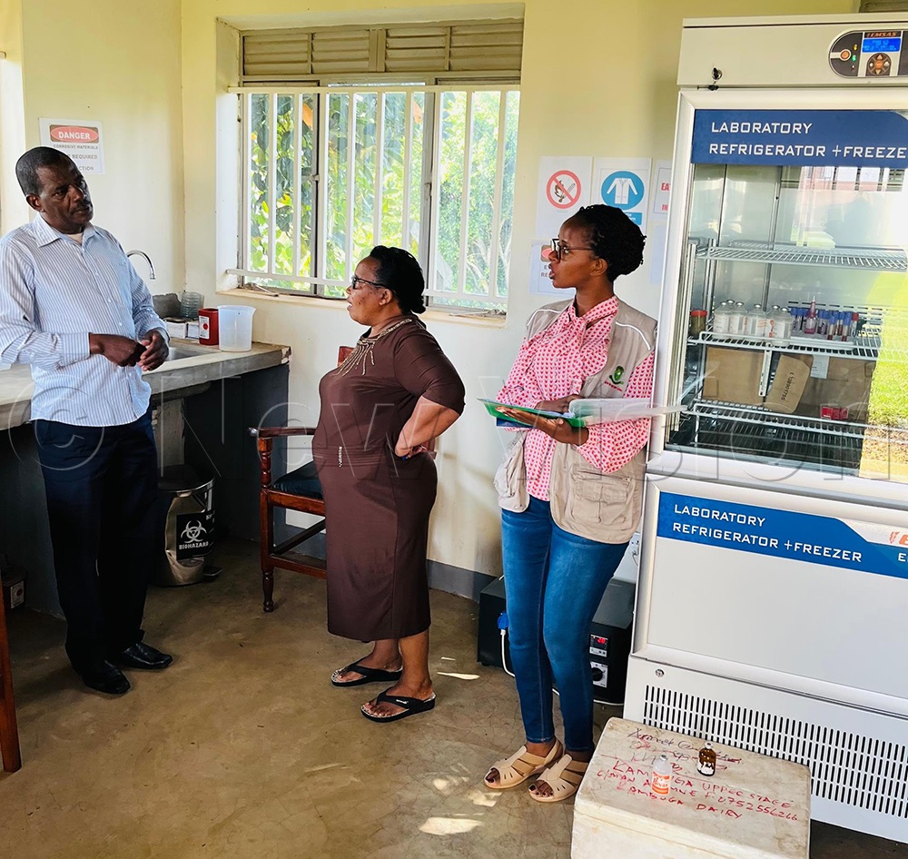 NDA officials showing the recommended vaccine laboratory refrigerator. (Credit: Abdulkarim Ssengendo))