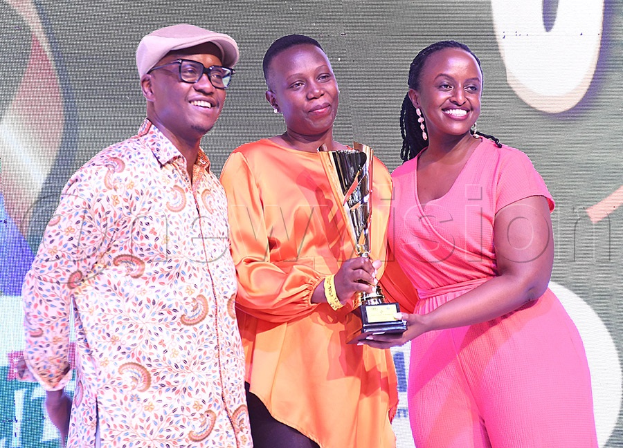 Martha Bisamaza (right) Senior Manager Corporate Performance hands over a trophy to Sheila Ajok as MTN Chief Finance Officer Andrew Bugembe (left) looks on after the MTN Quarterly Tees Golf Tournament at Entebbe Club, September 12, 2026. Photo by Michael Nsubuga