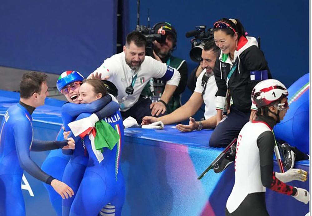 Italy team members celebrate after winning the short track speed skating mixed team relay gold, February. 10, 2026. (Xinhua/Li Ming)