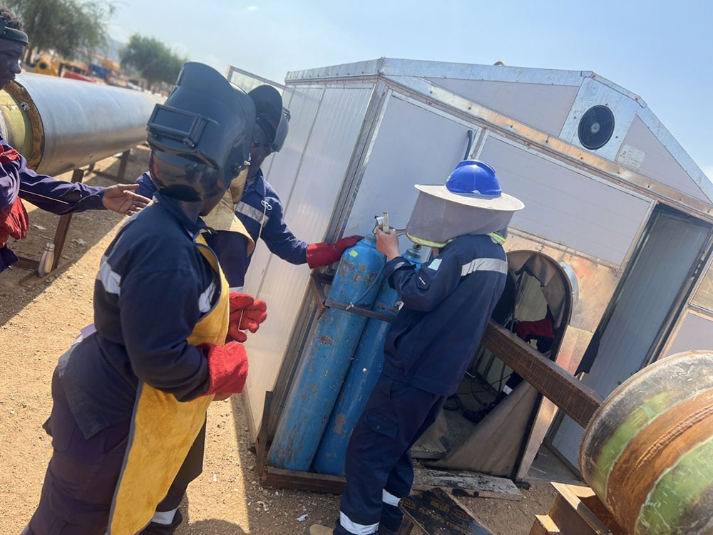 Local trainees get hands-on exposure to the automatic welding machine for the first time.