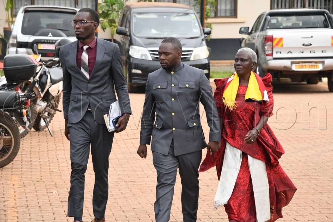 Dilidha Musa (centre) with a colleague Bukenya Ibrahim Nsamba and the grandmother Aisha Nanyonjo.