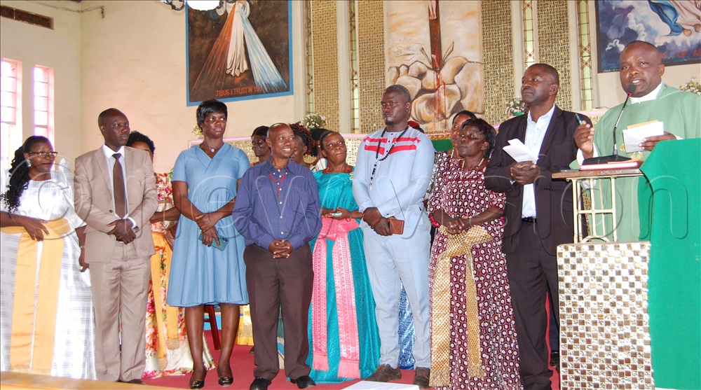 The Episcopal Vicar of Mitala-Maria Vicariate, Fr. Francis Xavier Kikomeko (right) announcing the cash collection from Mitala-Maria parish. With him are some of the leaders of the laity of the parish. 
