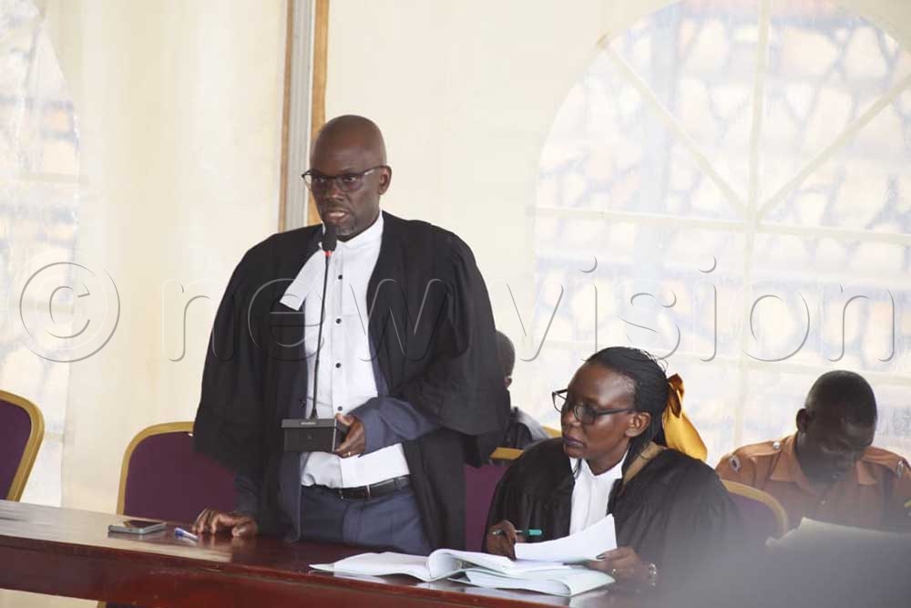 Christopher Onyum Okello's lawyers defend him during a court session on Monday. (Credit: Alfred Ochwo)