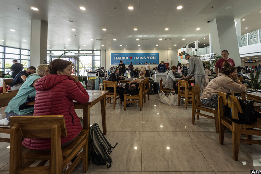 Stranded passengers wait for their flights at the Zanzibar International Airport on October 30, 2025