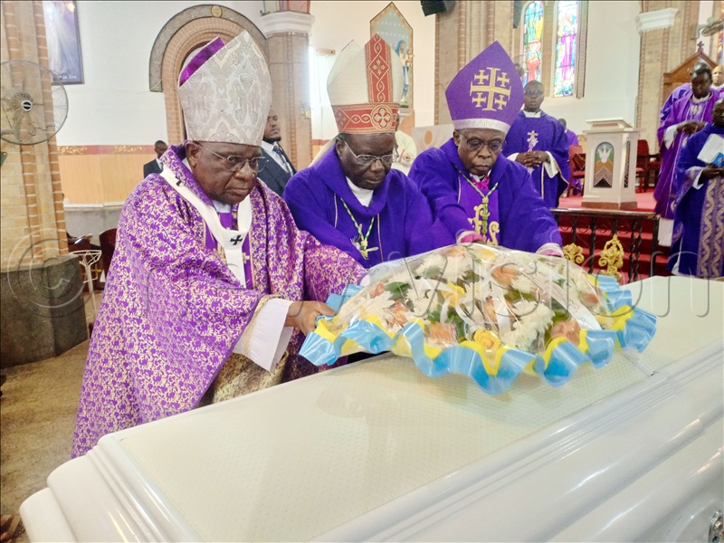 (L-R) Archbishop of Kampala, Paul Ssemogerere, Archbishop of Gulu Archdiocese, Raphael p'Mony Wokorach and Bishop of Kasana-Luweero Diocese, Lawrence Mukasa, lay a wreath on their colleague’s casket after a Requiem Mass at Lubaga Cathedral on Friday, October 23, 2025. (All Photos by Juliet Anna Lukwago)
