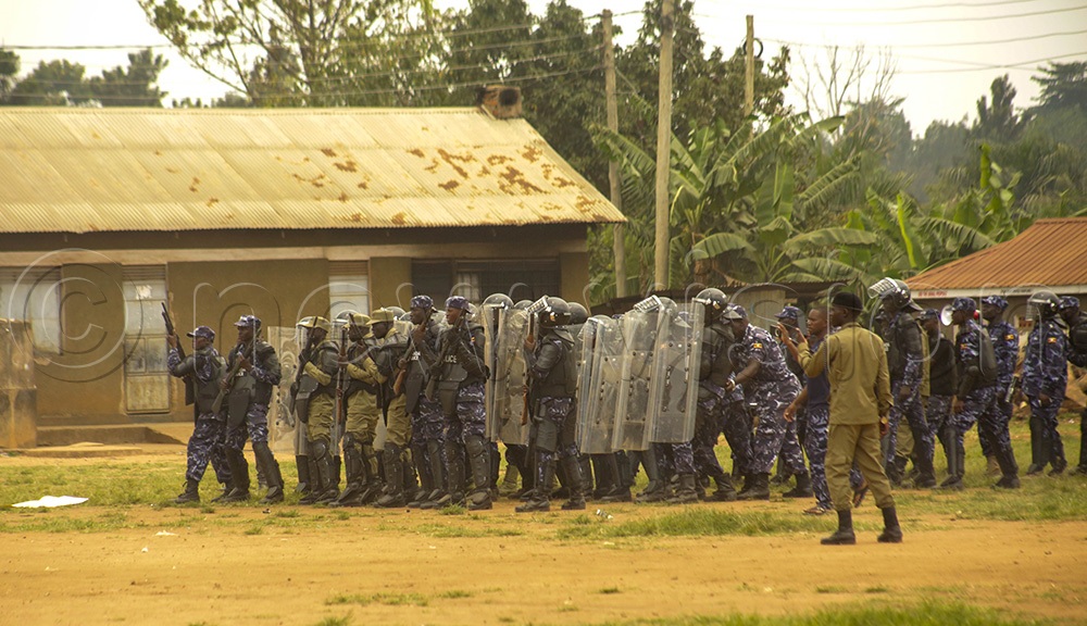 Police officers demonstrate riot control drills using shields and rubber bullets while simulating violent crowds. (Credit: Javier Silas Omagor)