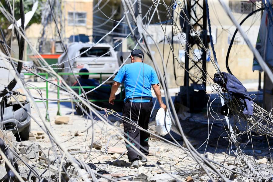 This photo taken on June 12, 2026 shows a citizen inspecting damaged buildings after a recent Israeli airstrike, in Tyre, Lebanon. (Photo by Xinhua)
