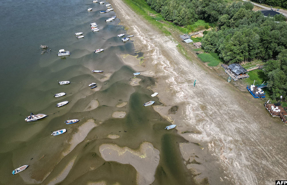 An aerial view taken on July 24, 2026 shows boats in the shallow water of the Danube river in Corabia, southern Romania