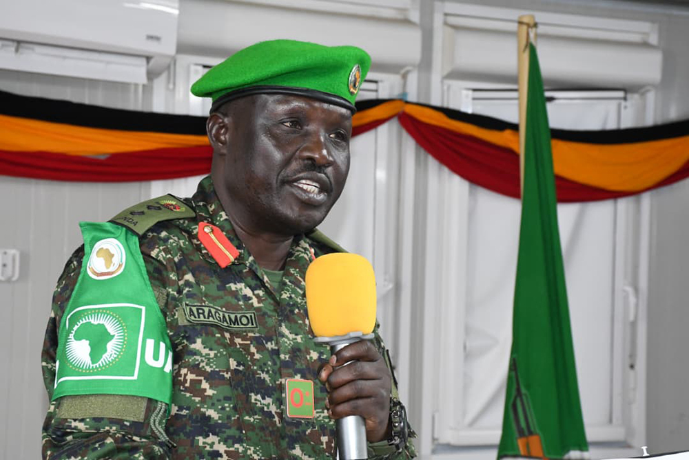 Col Francis Aragamoi reads his report during the handover and takeover ceremony. (Courtesy)