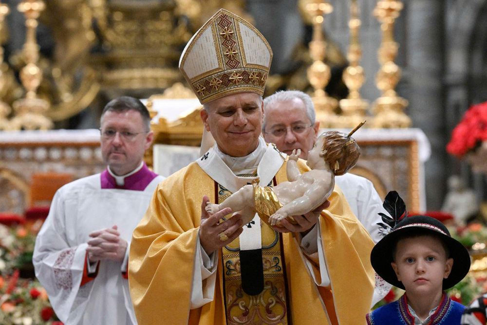 Pope Leo XIV carrying the statue of Baby Jesus at the end of the Christmas Eve mass at St. Peter's Basilica at the Vatican. (Photo by Simone Risoluti / VATICAN MEDIA / AFP)