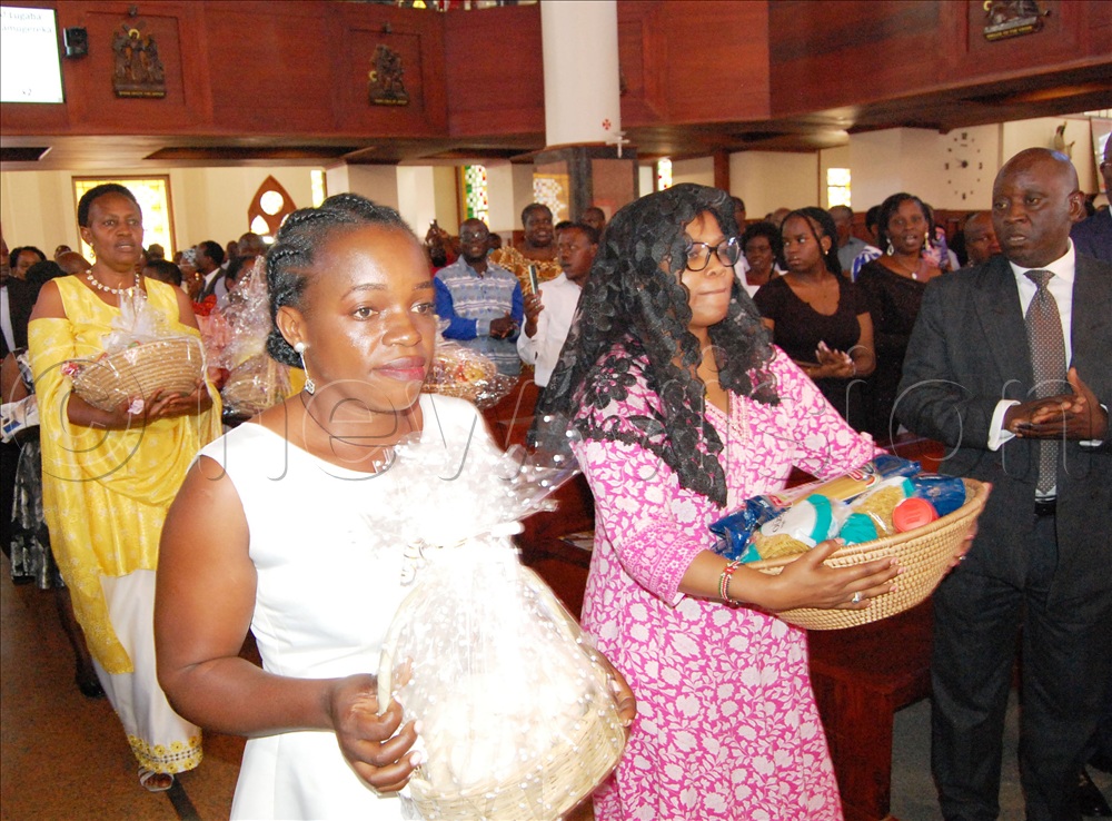 Christians carrying offertory during the Pontifical mass for the 95th anniversary of Christ the King Church Kampala on November 23, 2025.