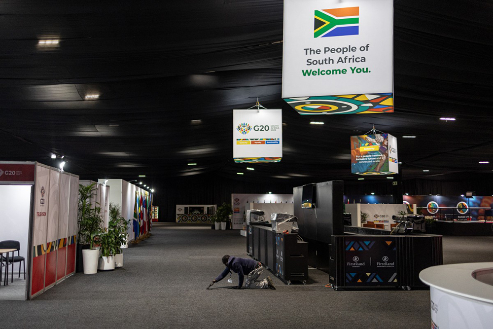 A worker repositions a carpet at the Nasrec Expo Centre, ahead of the G20 South Africa leader’s summit, in Johannesburg on November 18, 2025. 