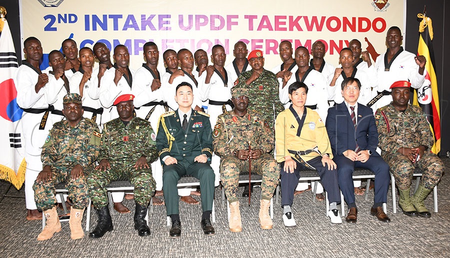 The UPDF Black Belts pose with UPDF Joint Staff Training and Doctrine Command (JS TRADOC) head Brigadier General Wycliffe Keita (seated-center) the Korea Embassy defense attaché the Col. Lee Jeongsu (seated 3rd left) and other UPDF officers. Photo by Michael Nsubuga