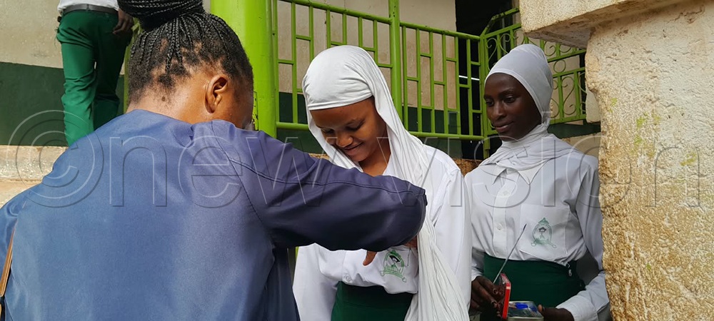 Students being checked before entering the exam room. (Credit: Edward Luyimbazi)