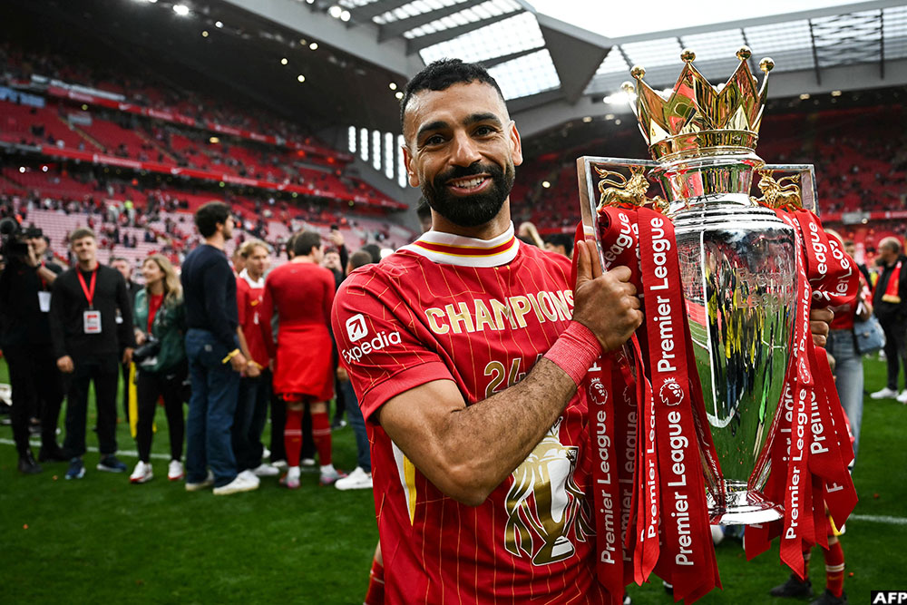 Liverpool's Salah celebrates with the Premier League trophy at the end of the 2024-2025 season. (AFP)