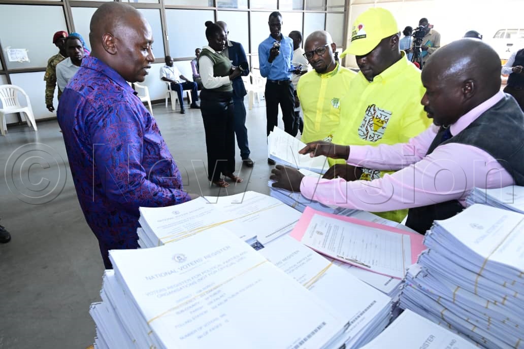 NRM secretary general, Richard Todwong, receiving the hard copies of the national voters register from the Electoral Commission (EC) headquarters in Kampala, ahead of polling day. (Credit: Mpalanyi Ssentongo)