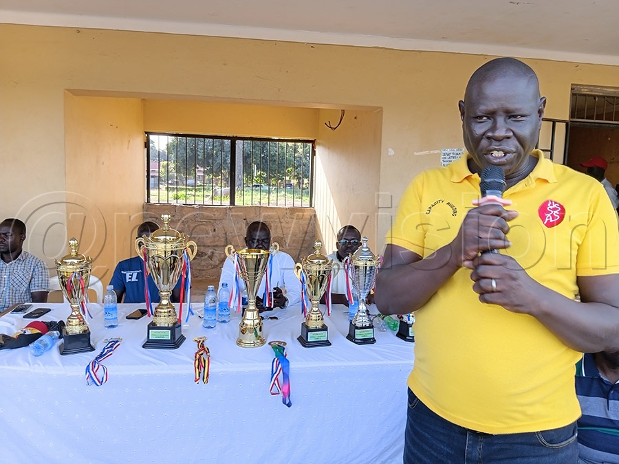 Joseph Ecegem, Soroti district USSSA chairperson, addressing athletes and presenting medals during the district secondary schools athletics championship
