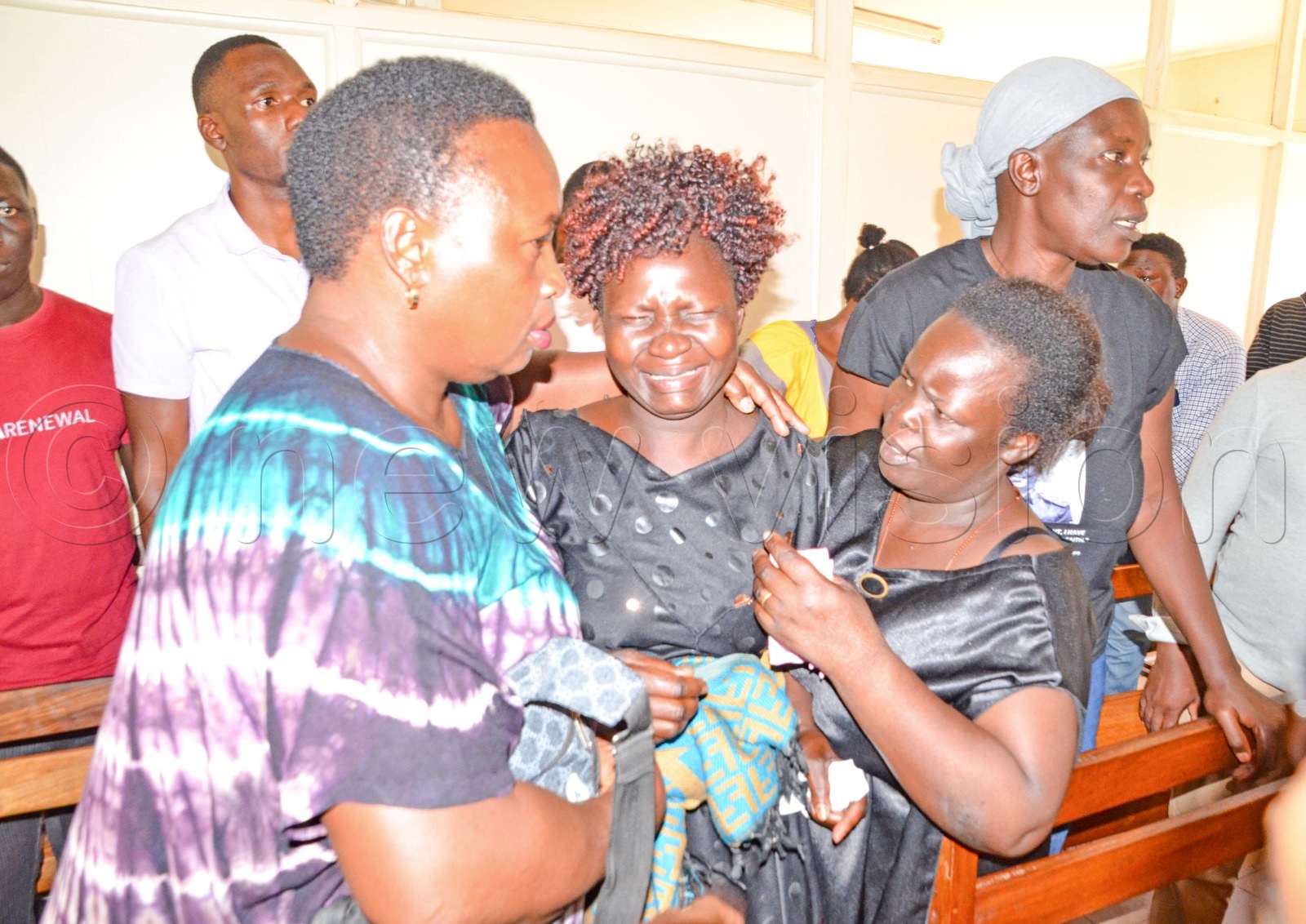 Family members of the children killed in the attack react during a break in proceedings at Makindye Chief Magistrates Court.