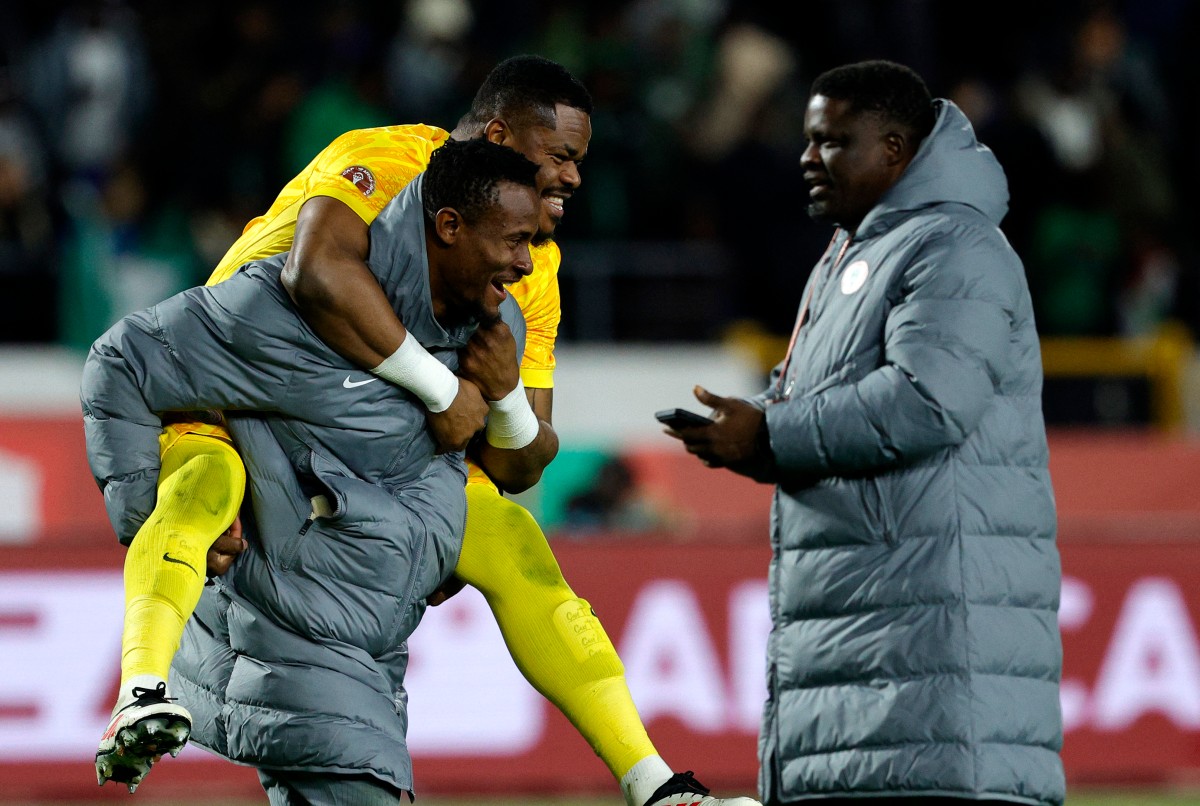 Nigeria's goalkeeper #16 Amas Obasogien carries Nigeria's goalkeeper #23 Stanley Nwabali after victory in the Africa Cup of Nations (CAN) third place football match between Egypt and Nigeria at the Mohammed V Stadium in Casablanca. (AFP Photo )