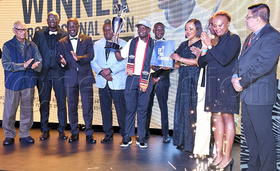 Rwandan Celestine Nsanzuwera (center) shows off his prizes as the galaxy of sponsors representatives applaud after the Johnnie Walker Uganda Golf Open Professionals championship at the Lugazi Hills Golf and Country Club. Photo by Michael Nsubuga
