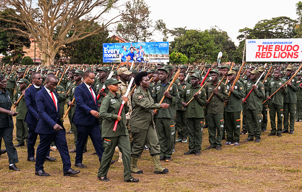 Commissioner Patriotism Helen Seku inspecting the parade during the passout of over 2500 patriotism students and teachers of Kings College Buddo on Saturday. (PPU Photo)