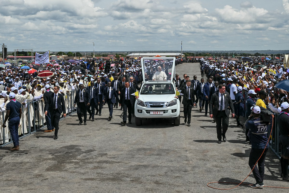 Pope Leo XIV (C) rides the Popemobile as he arrives to lead the Holy Mass at the Saurimo esplanade in Saurimo on the eighth day of an 11-day apostolic journey to Africa, on April 20, 2026. 