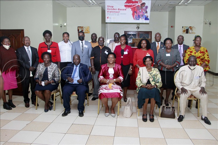 Peace Mutuuzo (seated Center), Minister of State for Gender, Labour and Social Development with other guests taking a group photo.  