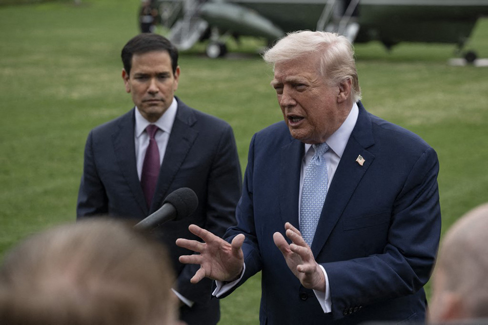 United States President Donald Trump (R) speaks to the press before his departs the White House en route Miami, Florida on March 20, 2026, in Washington DC. Also The United States Secretary of State Marco Rubio (L) is seen. (Photo by Celal Gunes / Anadolu via AFP)