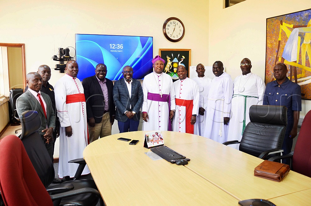 Vision Group CEO Don Wanyama (middle) poses for a photo with Mukono Diocese Bishop Rt. Rev. Enos Kitto Kagodo and other clerics during their visit. (Photo by Isaac Nuwagaba)