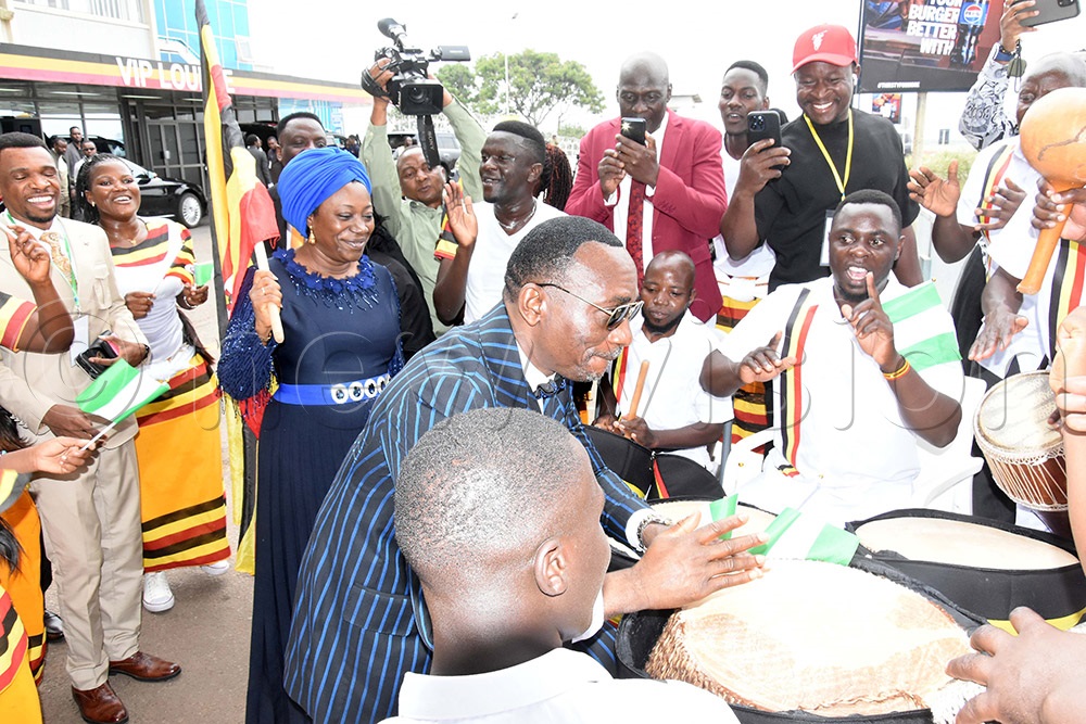 Dr Pastor Paul Enenche centre from Nigeria druming upon is arrival at Entebbe International Airport while his wife Pastor Dr Mrs Becky Paul-Enenche looks on. (Photo by Ponsiano Nsimbi)