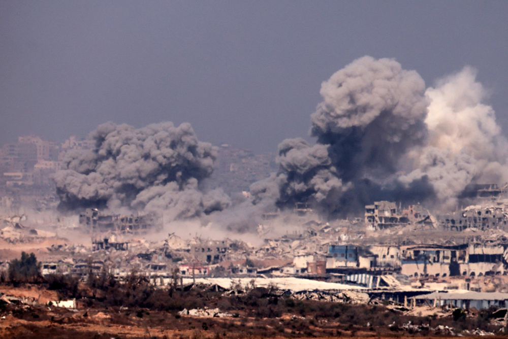 This picture taken from a position at Israel's border with the Gaza Strip shows thick smoke billowing during Israeli strikes on the besieged Palestinian territory on July 27, 2025. (Photo by Menahem KAHANA / AFP)