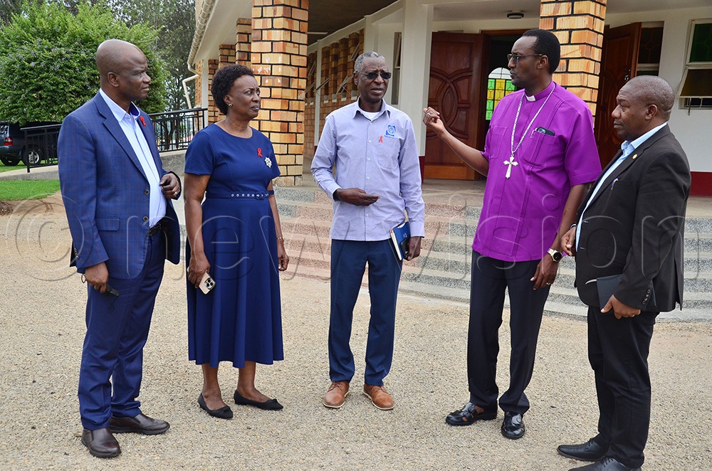 The Bishop of Ankole Diocese, the Rt Rev Alfred Muhoozi, having a chat with officials from Uganda AIDS Comission (UAC). (Photo by Agnes Kyotalengerire)