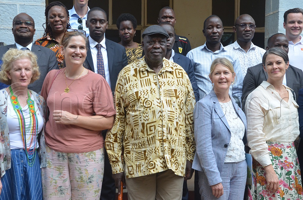 Ambassadors pose for a photo with Karamoja affairs minister Peter Lokeris at the Moroto district chamber hall. (Photo by Olandason Wanyama)